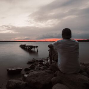 man looks into a distant sunset symbolizing what ketamine treats